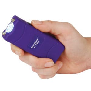Compact Lil Guy 12 Million Volt Purple Stun Gun with 100 Lumen LED Flashlight Viewed in Persons Hand