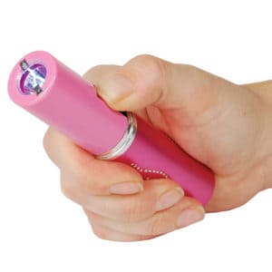 Pink Stun Master Lipstick Rechargeable Stun Gun with Flashlight Shown in women Hand