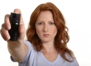 Woman Spraying Pepper Spray front view