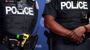 Police standing with Stun gun tasers holstered