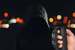 Zap Extreme Stun Gun against hooded figure in the streets at night