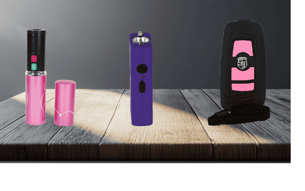 Three stun guns ideal for women. Displayed on a table featuring lipstick stun gun, little guy stun gun and the Triad stun gun.